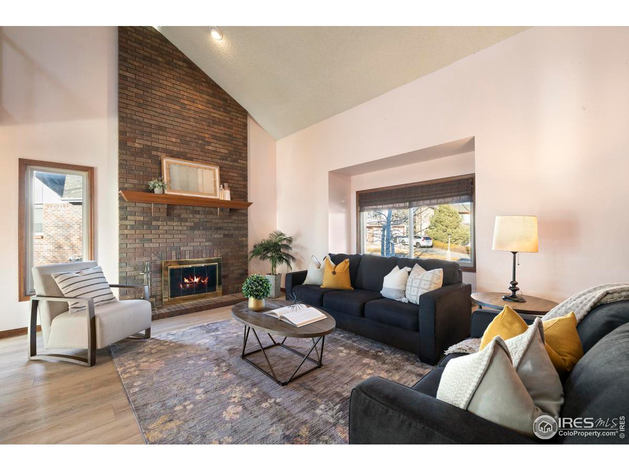 2713 Beech Way Longmont, CO 80503 - Photo 6 of 36 a living room with furniture and a fireplace