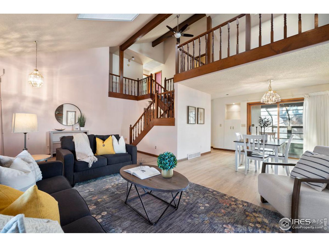 2713 Beech Way Longmont, CO 80503 - Photo 8 of 36 a living room with couches a dining table and chairs with outer view
