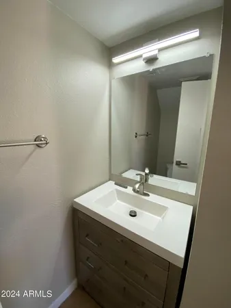 a bathroom with a sink and mirror