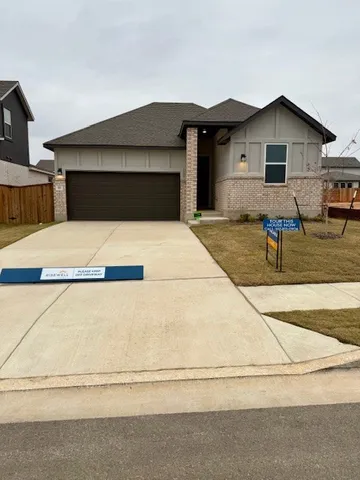 a front view of a house with garage