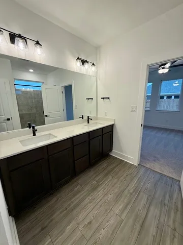 a bathroom with a double vanity sink and mirror