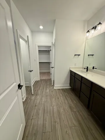 a room with wooden floors and a sink