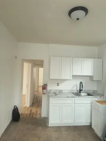 a kitchen with cabinets appliances and a counter top