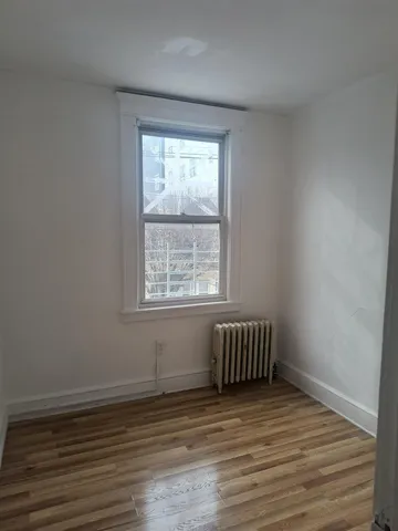wooden floor with window in an empty room