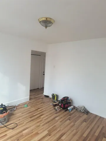 a view of a room with wooden floor and closet