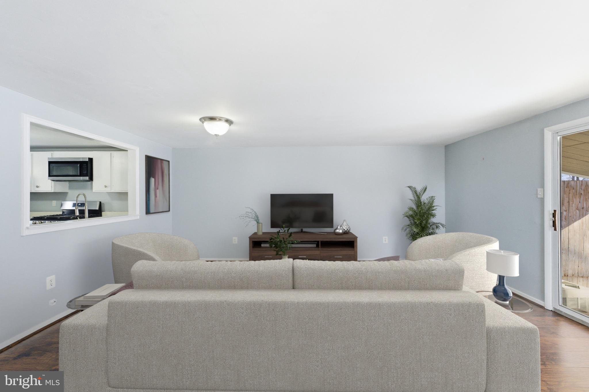 14629 Sandy Ridge Road Silver Spring, MD 20905 - Photo 12 of 47 a living room with furniture and a flat screen tv