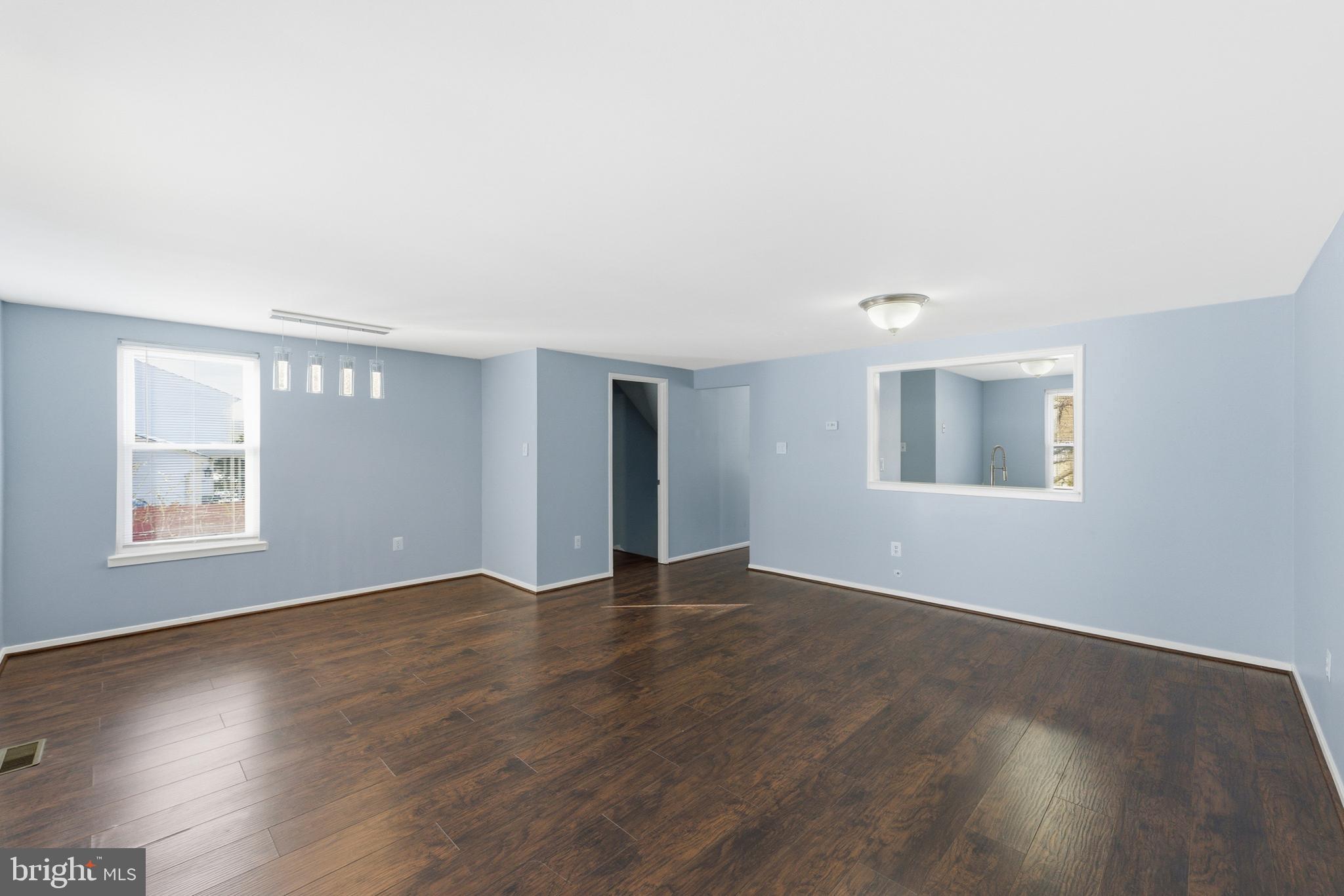 14629 Sandy Ridge Road Silver Spring, MD 20905 - Photo 13 of 47 an empty room with wooden floor and windows