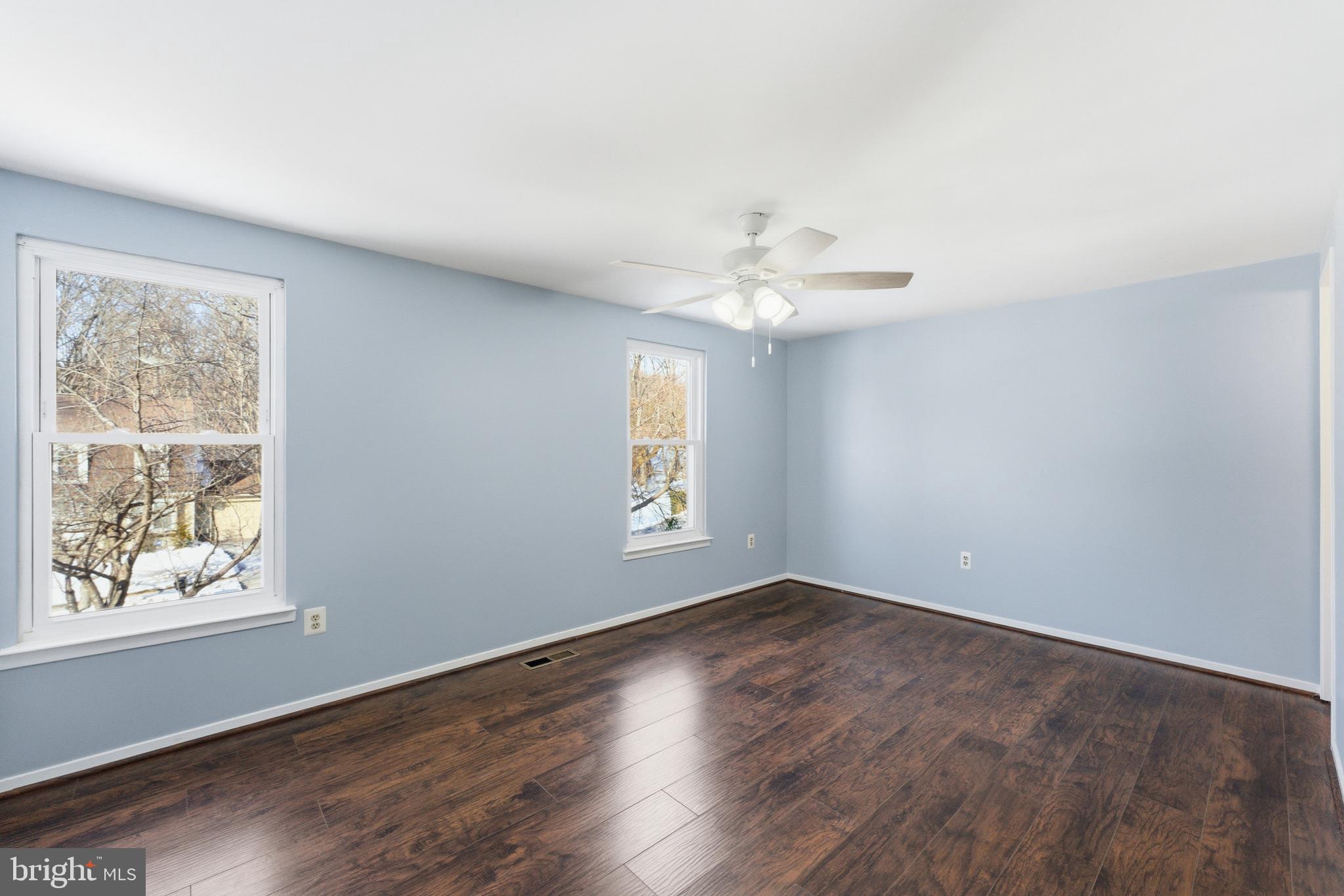 14629 Sandy Ridge Road Silver Spring, MD 20905 - Photo 17 of 47 a view of an empty room with wooden floor and a window