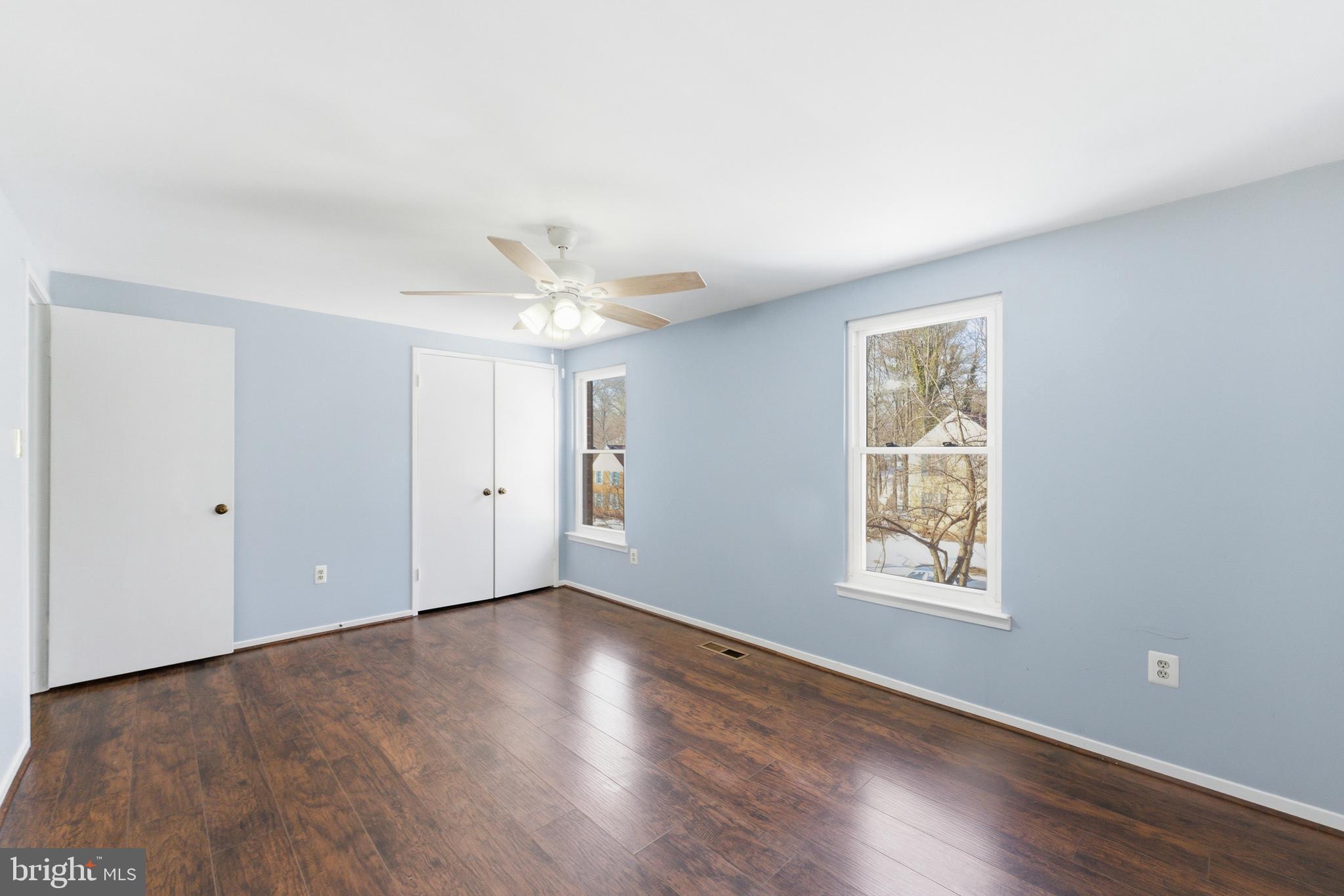 14629 Sandy Ridge Road Silver Spring, MD 20905 - Photo 21 of 47 a view of an empty room with wooden floor and a window