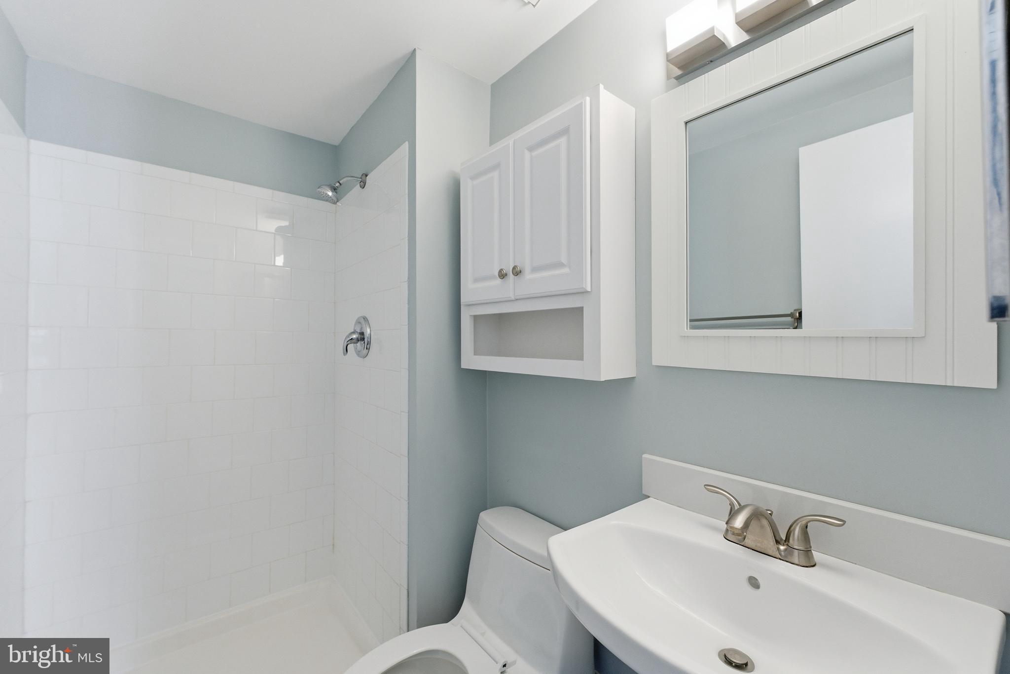 14629 Sandy Ridge Road Silver Spring, MD 20905 - Photo 23 of 47 a bathroom with a toilet sink and mirror