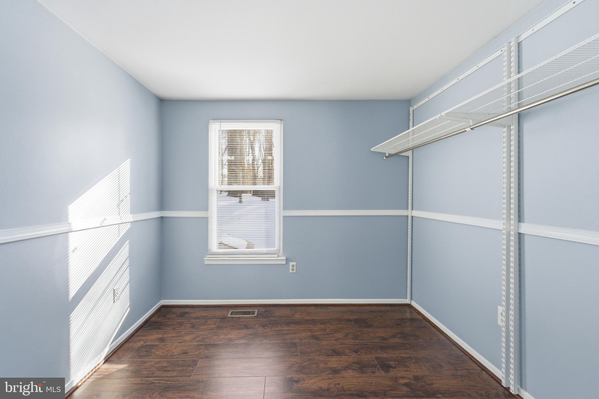 14629 Sandy Ridge Road Silver Spring, MD 20905 - Photo 26 of 47 an empty room with wooden floor and windows