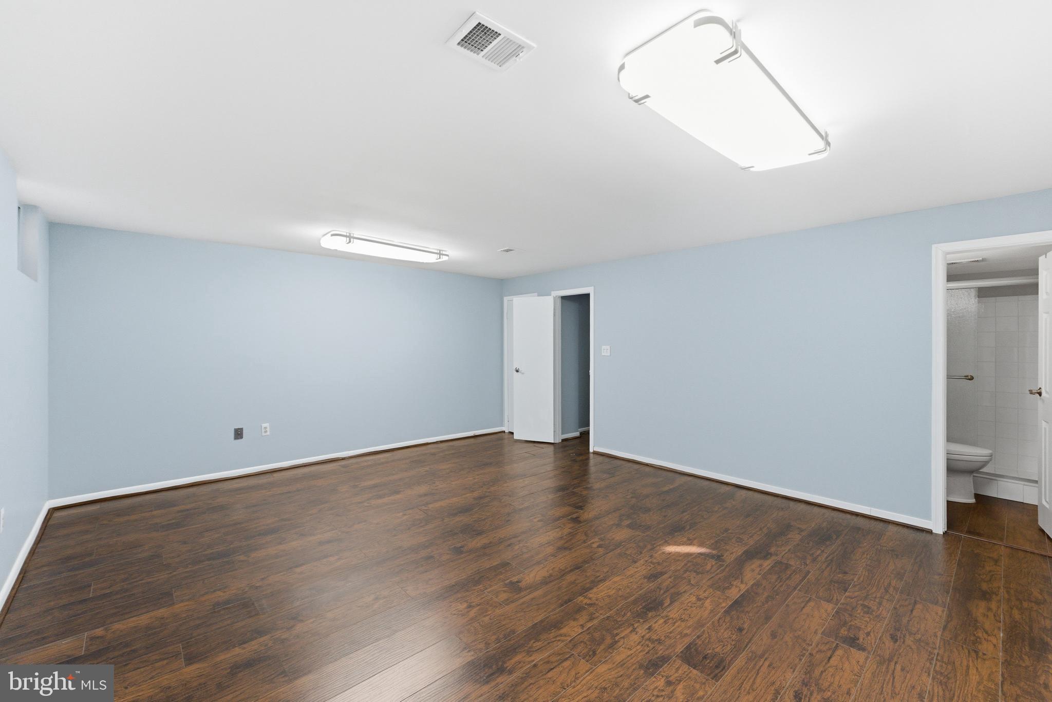 14629 Sandy Ridge Road Silver Spring, MD 20905 - Photo 30 of 47 wooden floor in an empty room with a window