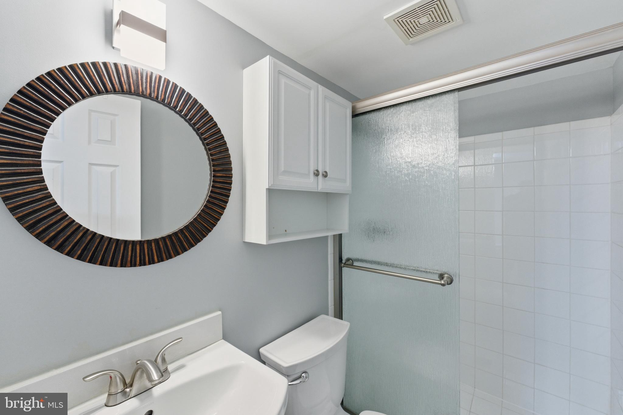 14629 Sandy Ridge Road Silver Spring, MD 20905 - Photo 34 of 47 a bathroom with a toilet a sink and a mirror