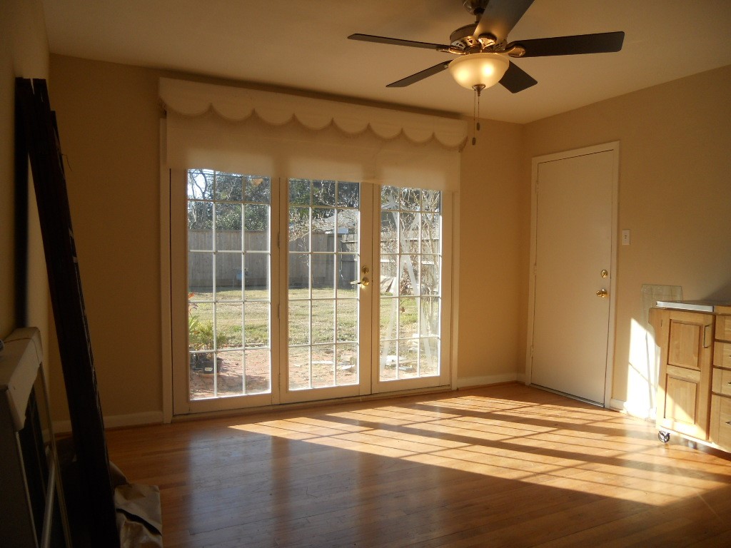 4709 Sanford Road Houston, TX 77035 - Photo 6 of 19 a view of a livingroom with wooden floor and a ceiling fan