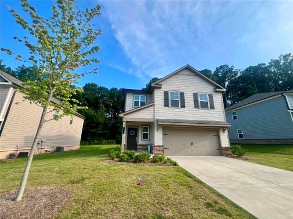 683 Evergreen Road Winder, GA 30680 - Photo 2 of 37 a front view of a house with garden