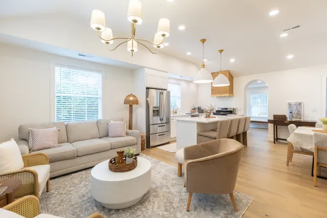 a living room with furniture kitchen and a window