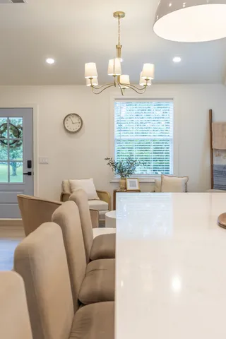a living room with furniture a window and a chandelier