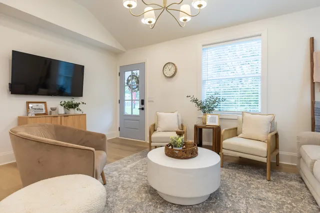a living room with furniture and a flat screen tv