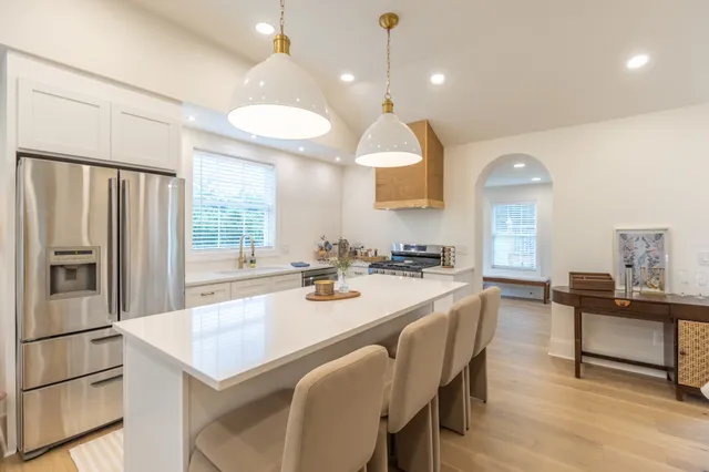 a large kitchen with a table and chairs