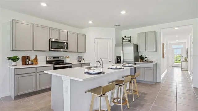 a kitchen with a sink stove and white cabinets
