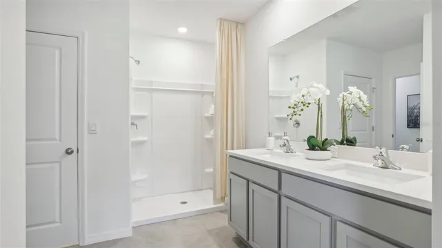 a bathroom with a double vanity sink and mirror