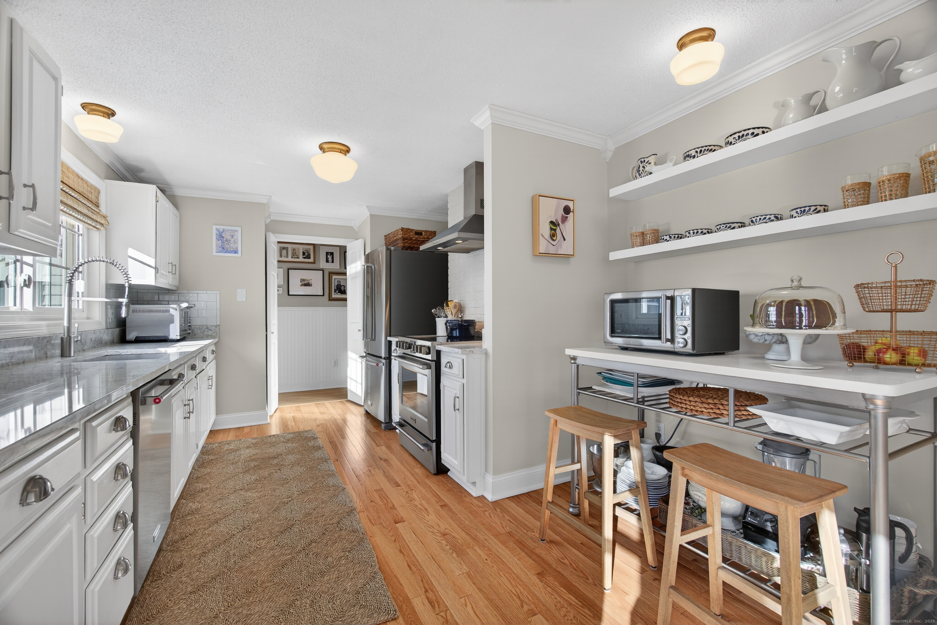84 Hop Brook Road Simsbury, CT 06070 - Photo 12 of 36 a kitchen with stainless steel appliances a stove top oven a sink a refrigerator and cabinets