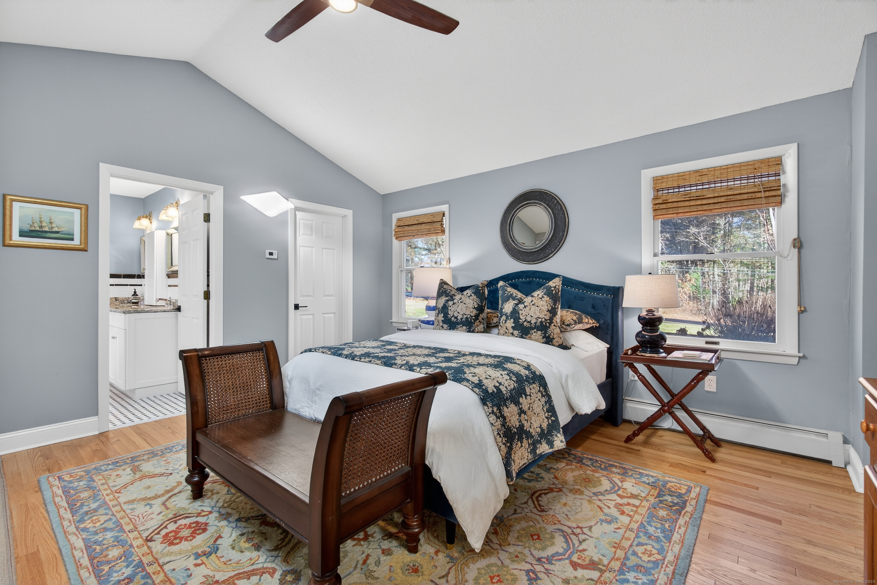 84 Hop Brook Road Simsbury, CT 06070 - Photo 17 of 36 a bedroom with bed and a clock on dresser with wooden floor
