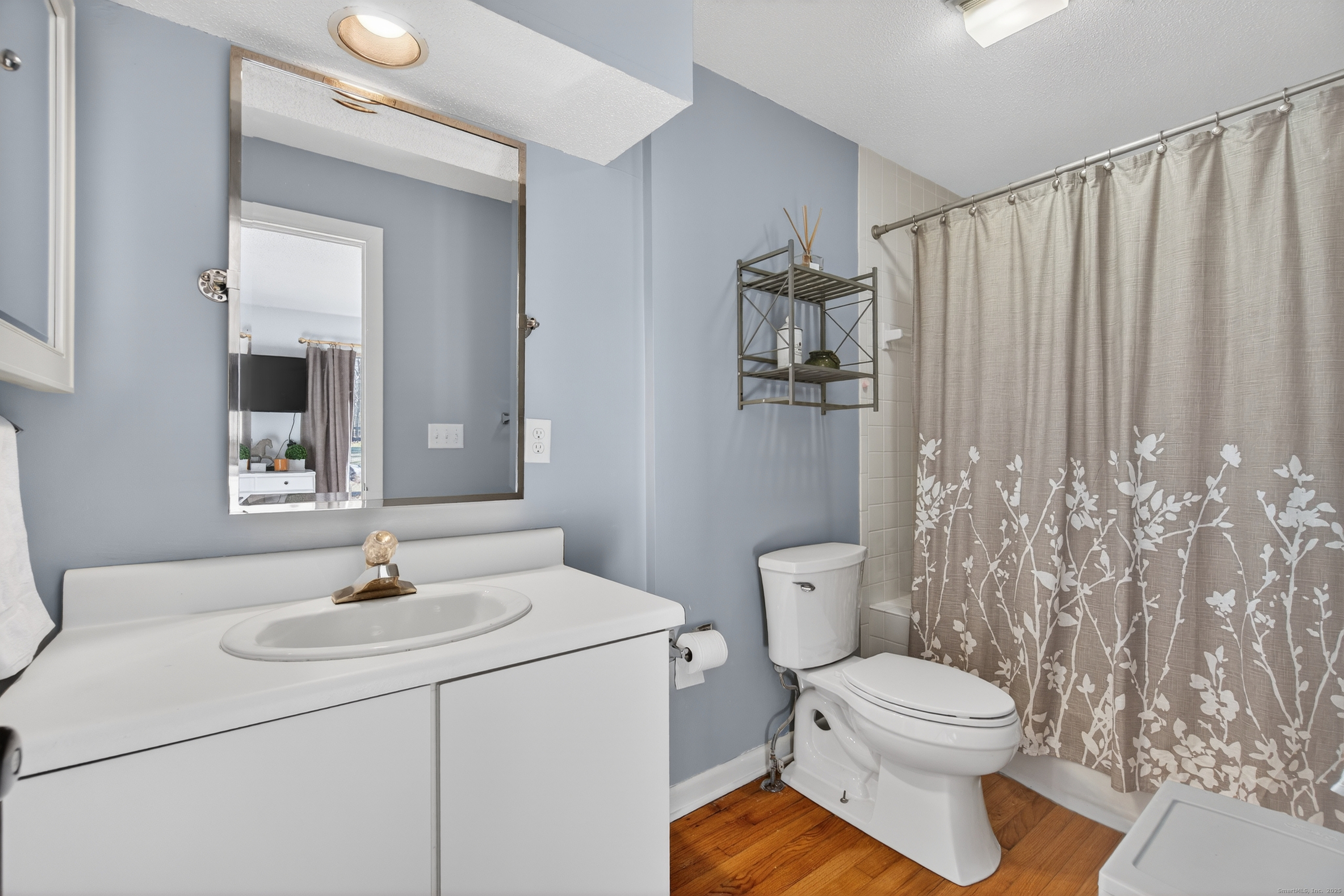 84 Hop Brook Road Simsbury, CT 06070 - Photo 24 of 36 a bathroom with a sink a toilet and shower curtain