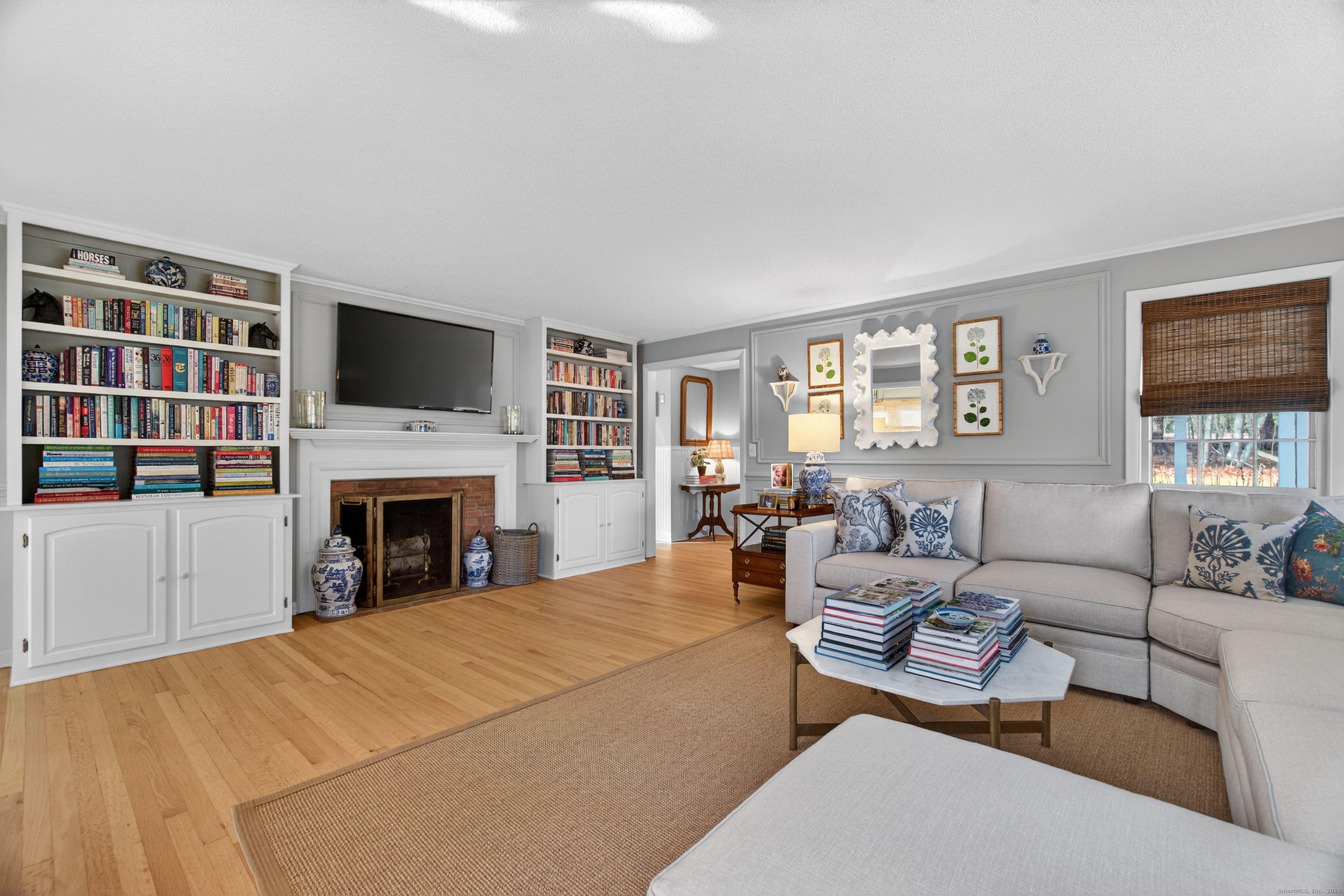84 Hop Brook Road Simsbury, CT 06070 - Photo 7 of 36 a living room with furniture a fireplace and a flat screen tv