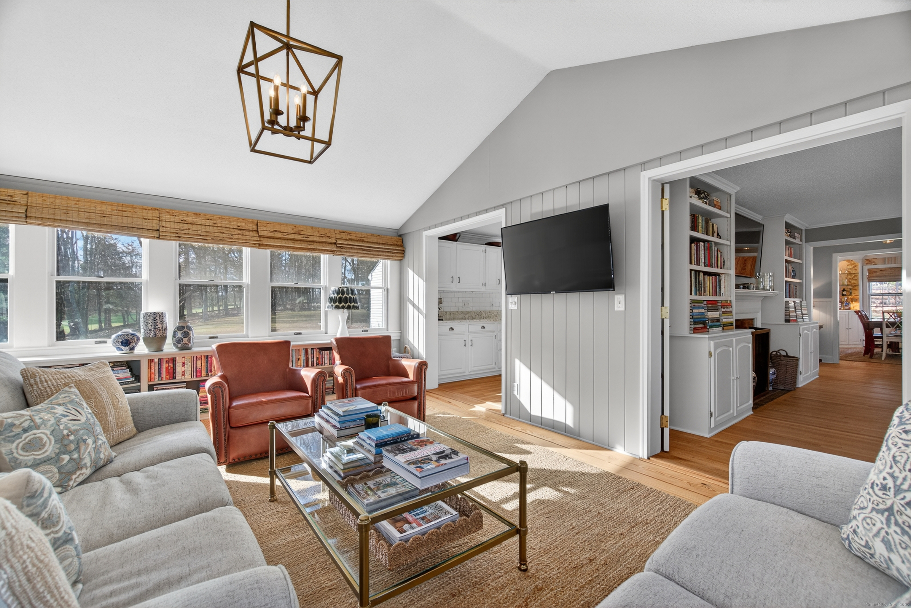 84 Hop Brook Road Simsbury, CT 06070 - Photo 9 of 36 a living room with furniture a flat screen tv and a large window