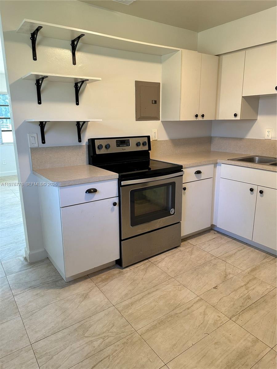 22840 Southwest 155th Avenue, Unit 2 Miami, FL 33170 - Photo 4 of 13 a kitchen with stainless steel appliances granite countertop a sink stove and cabinets