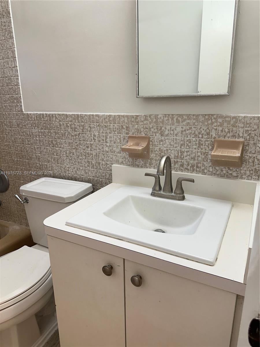 22840 Southwest 155th Avenue, Unit 2 Miami, FL 33170 - Photo 10 of 13 a bathroom with a sink a toilet and mirror