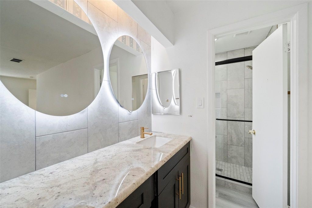 Beautiful oversized stand-up shower and LED mirrors