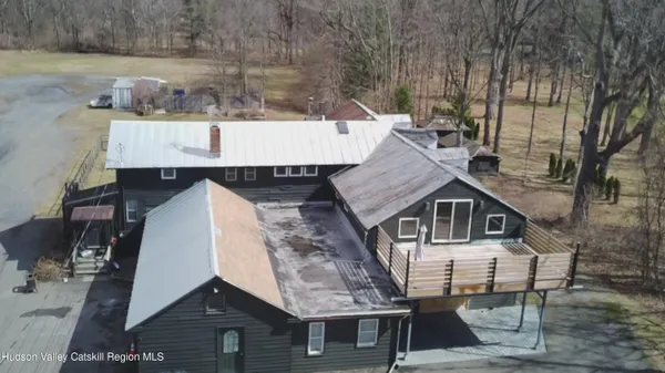 an aerial view of a house with a yard and balcony