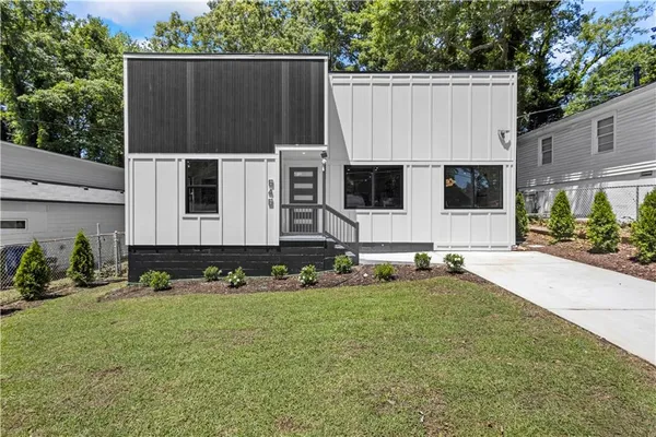 a view of a house with backyard and sitting area