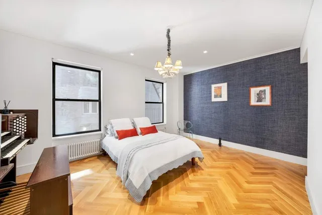 a bedroom with a bed and a chandelier