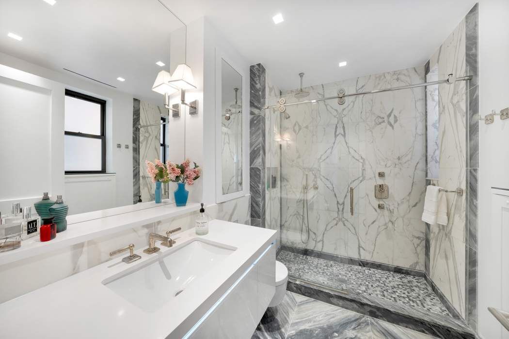 1356 Madison Avenue, Unit 3S Manhattan, NY 10128 - Photo 12 of 16 a bathroom with a double vanity sink mirror and shower