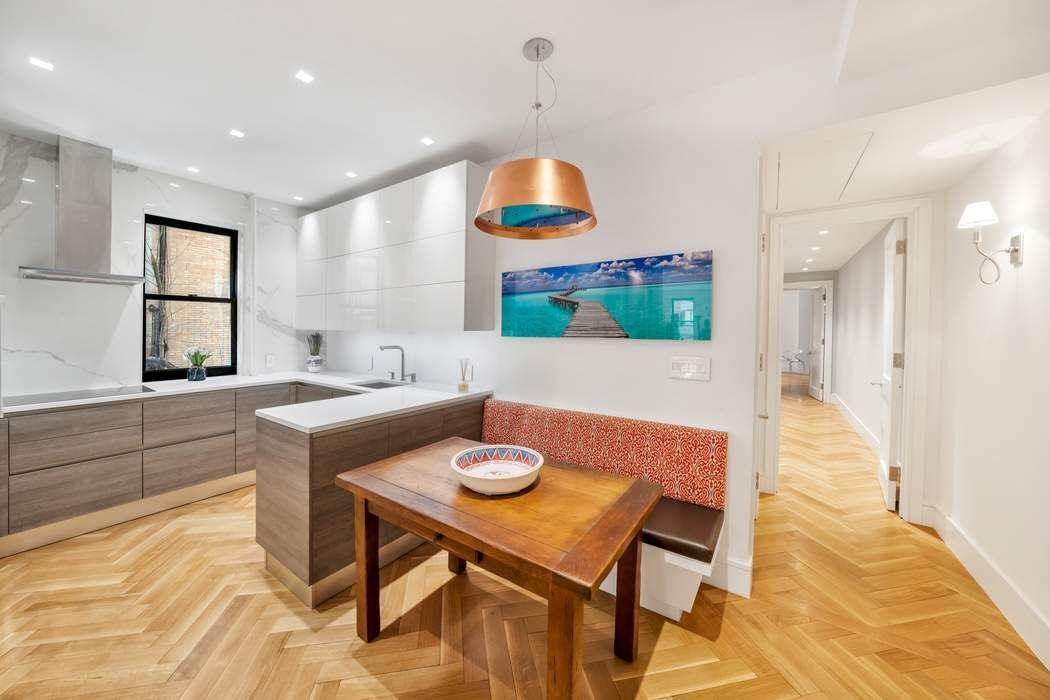 1356 Madison Avenue, Unit 3S Manhattan, NY 10128 - Photo 6 of 16 a kitchen with a table and chairs