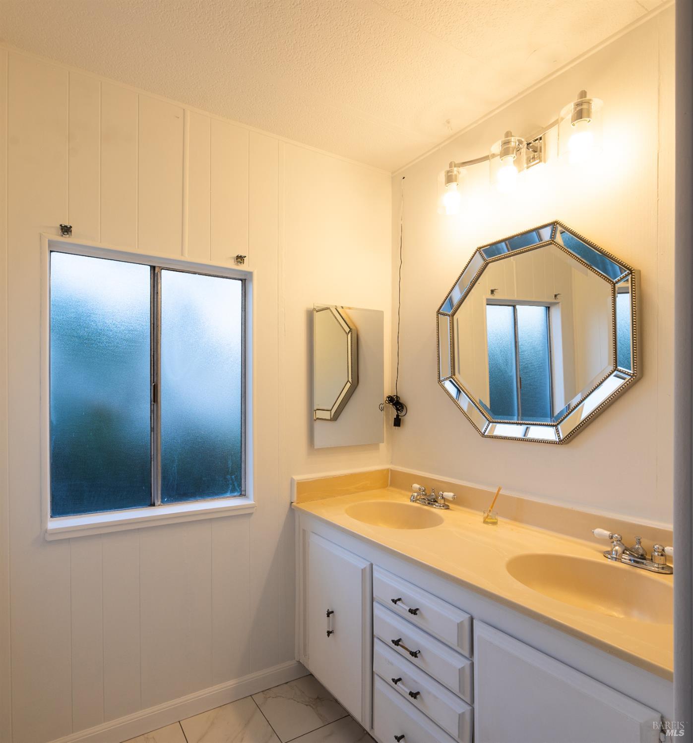 275 Carlsbad Court San Rafael, CA 94903 - Photo 23 of 32 a bathroom with a sink and a mirror