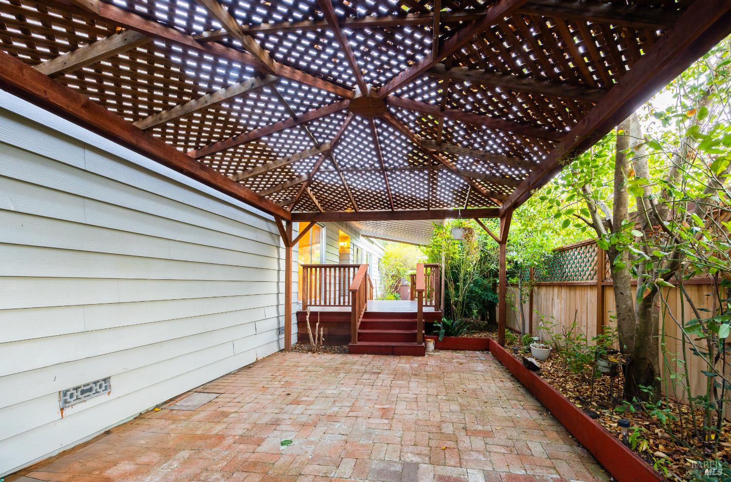 275 Carlsbad Court San Rafael, CA 94903 - Photo 9 of 32 a backyard of a house with wooden fence and large trees