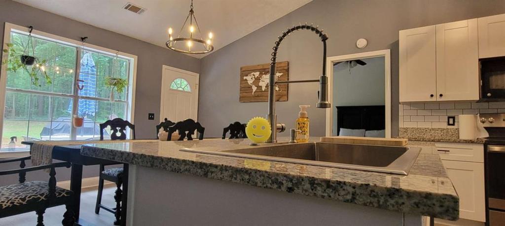 2140 Summerset Drive Monroe, GA 30656 - Photo 13 of 43 a kitchen with sink a faucet and chairs