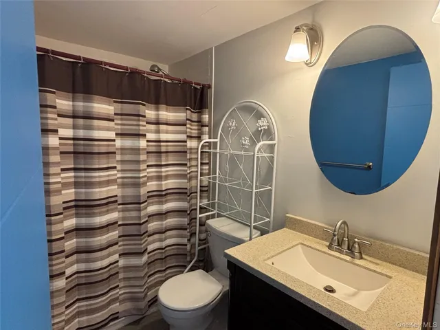 a bathroom with a bath tub with a glass shower door