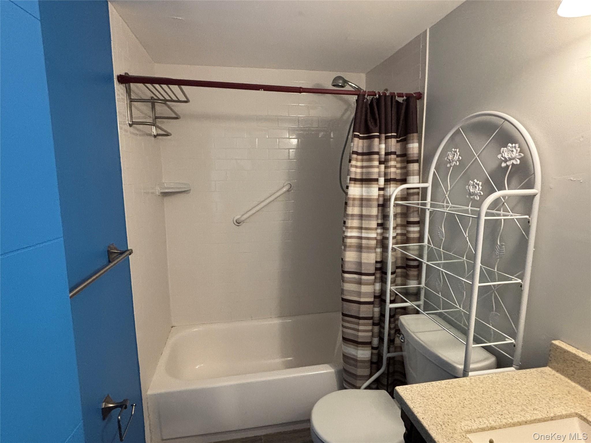 40 Canoe Place Road, Unit 4 Hampton Bays, NY 11946 - Photo 19 of 36 a bathroom with a toilet and shower