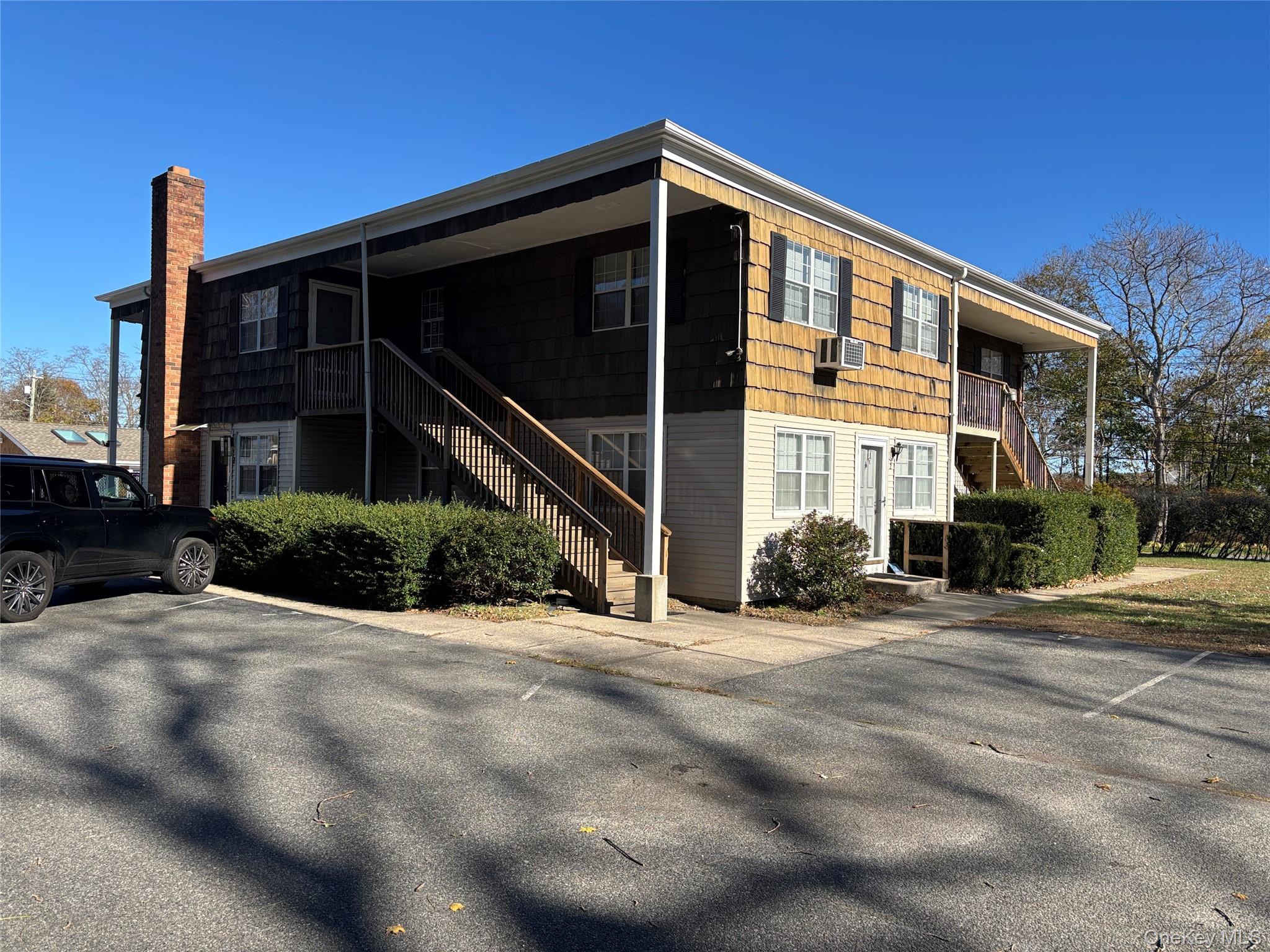 40 Canoe Place Road, Unit 4 Hampton Bays, NY 11946 - Photo 28 of 36 a front view of a house with yard