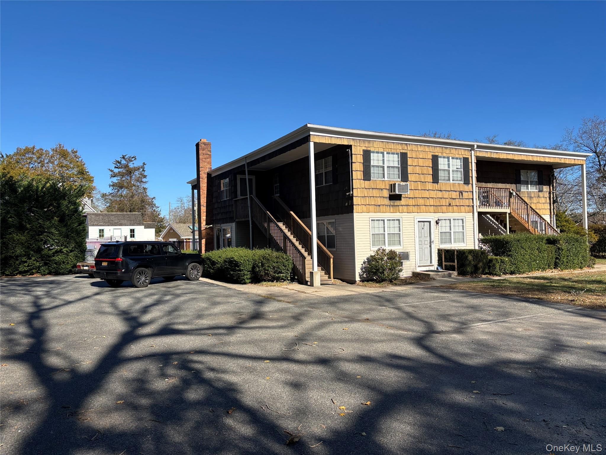 40 Canoe Place Road, Unit 4 Hampton Bays, NY 11946 - Photo 29 of 36 a front view of a house with a yard