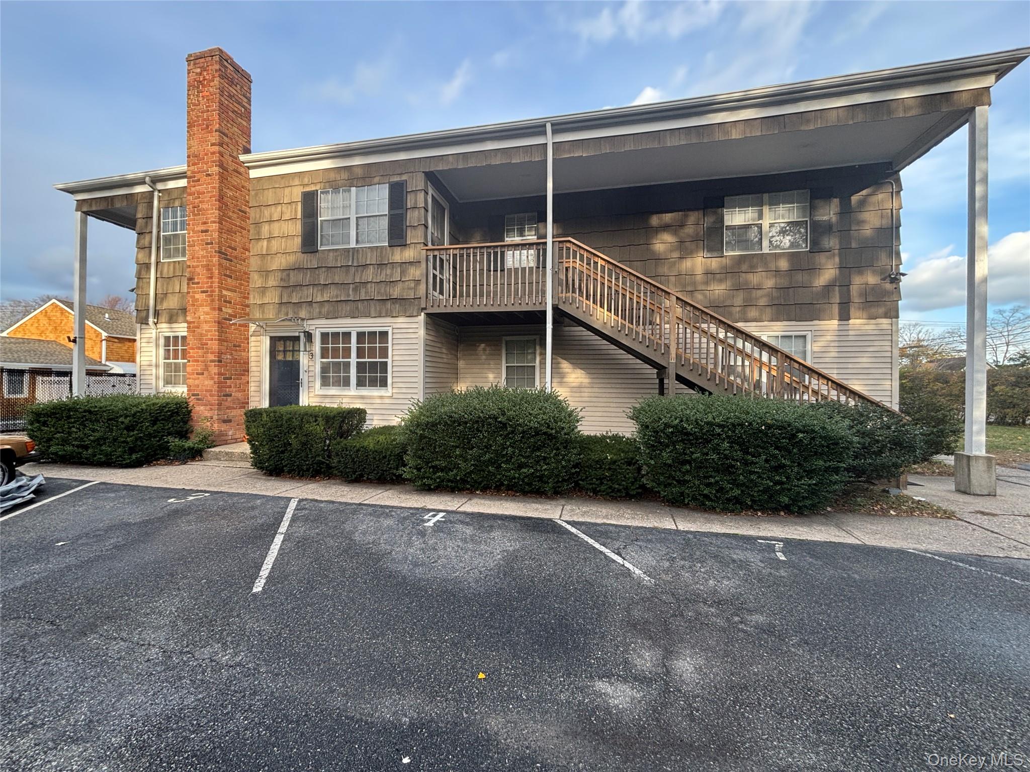 40 Canoe Place Road, Unit 4 Hampton Bays, NY 11946 - Photo 30 of 36 a view of a house with a street
