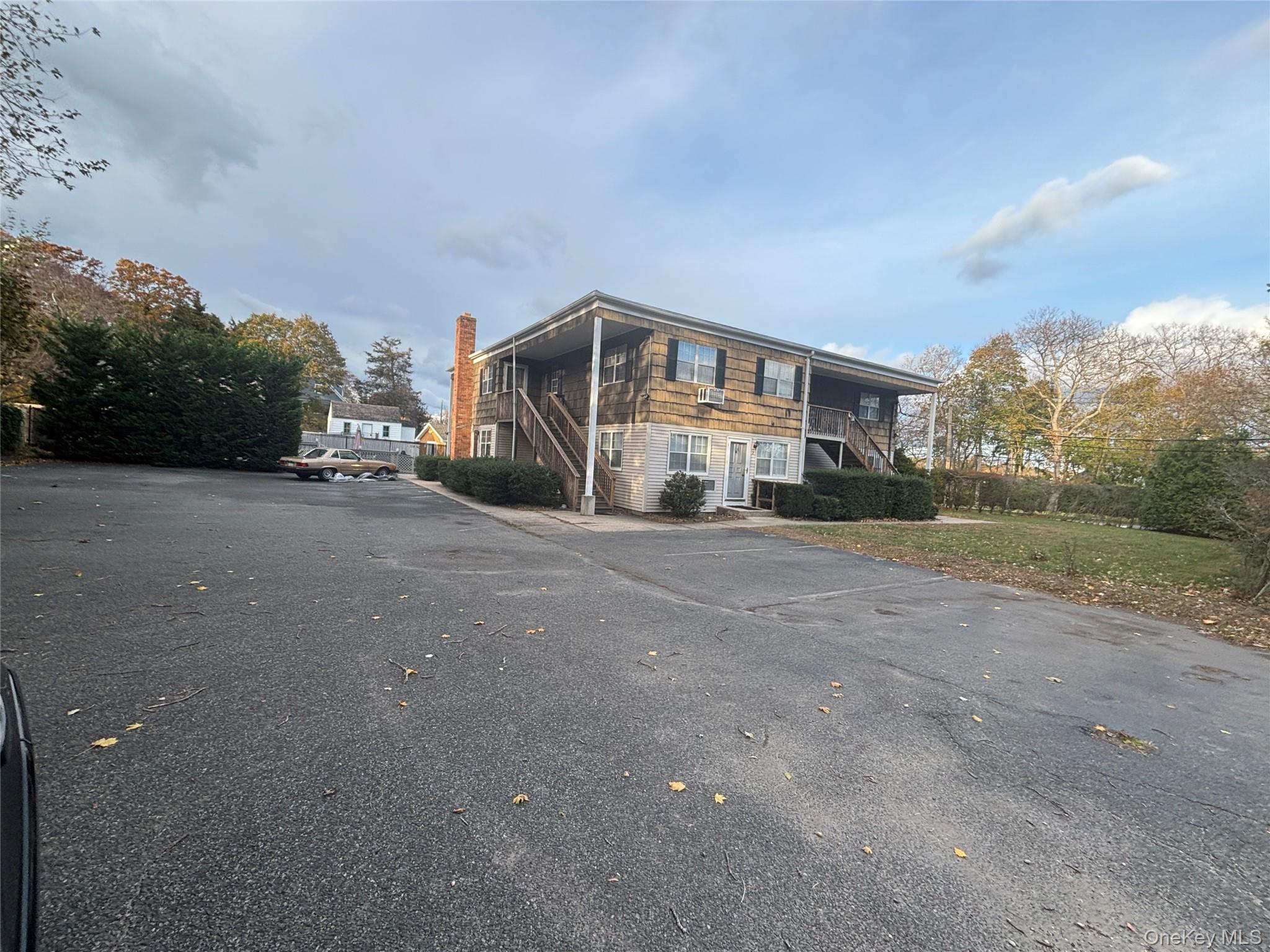 40 Canoe Place Road, Unit 4 Hampton Bays, NY 11946 - Photo 31 of 36 a view of a house with a street