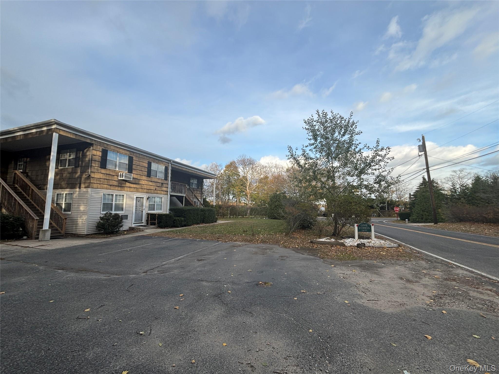 40 Canoe Place Road, Unit 4 Hampton Bays, NY 11946 - Photo 32 of 36 View of street with traffic signs and stairway