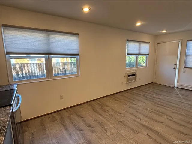 a kitchen with white cabinets stainless steel appliances and a refrigerator