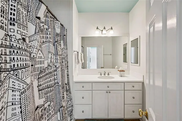 a bathroom with a double vanity sink mirror and